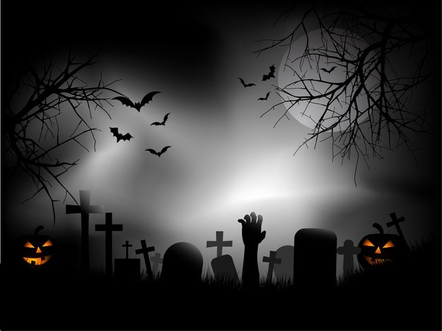 Spooky graveyard with zombie hand coming out ground